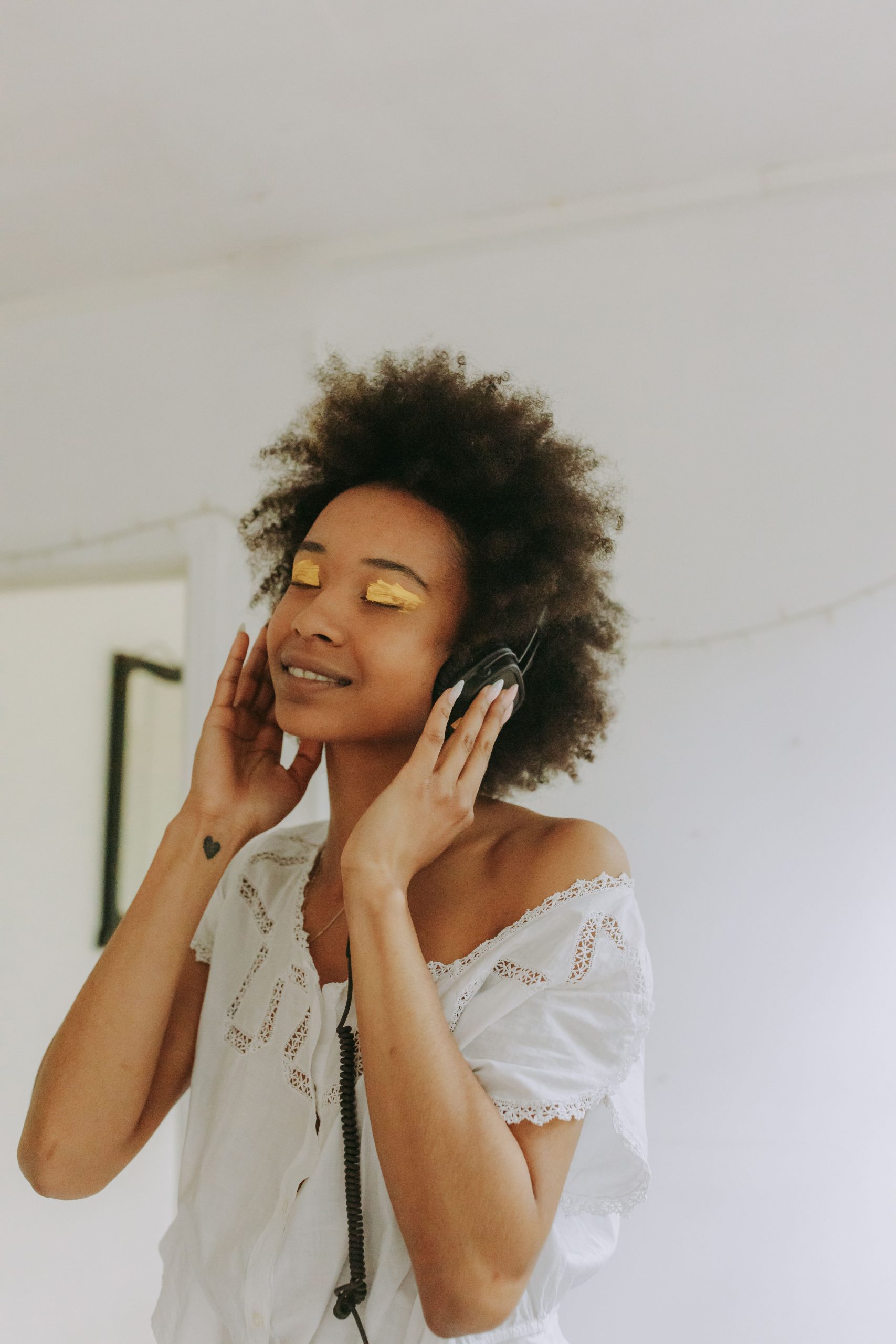 woman listening to music with large headphones