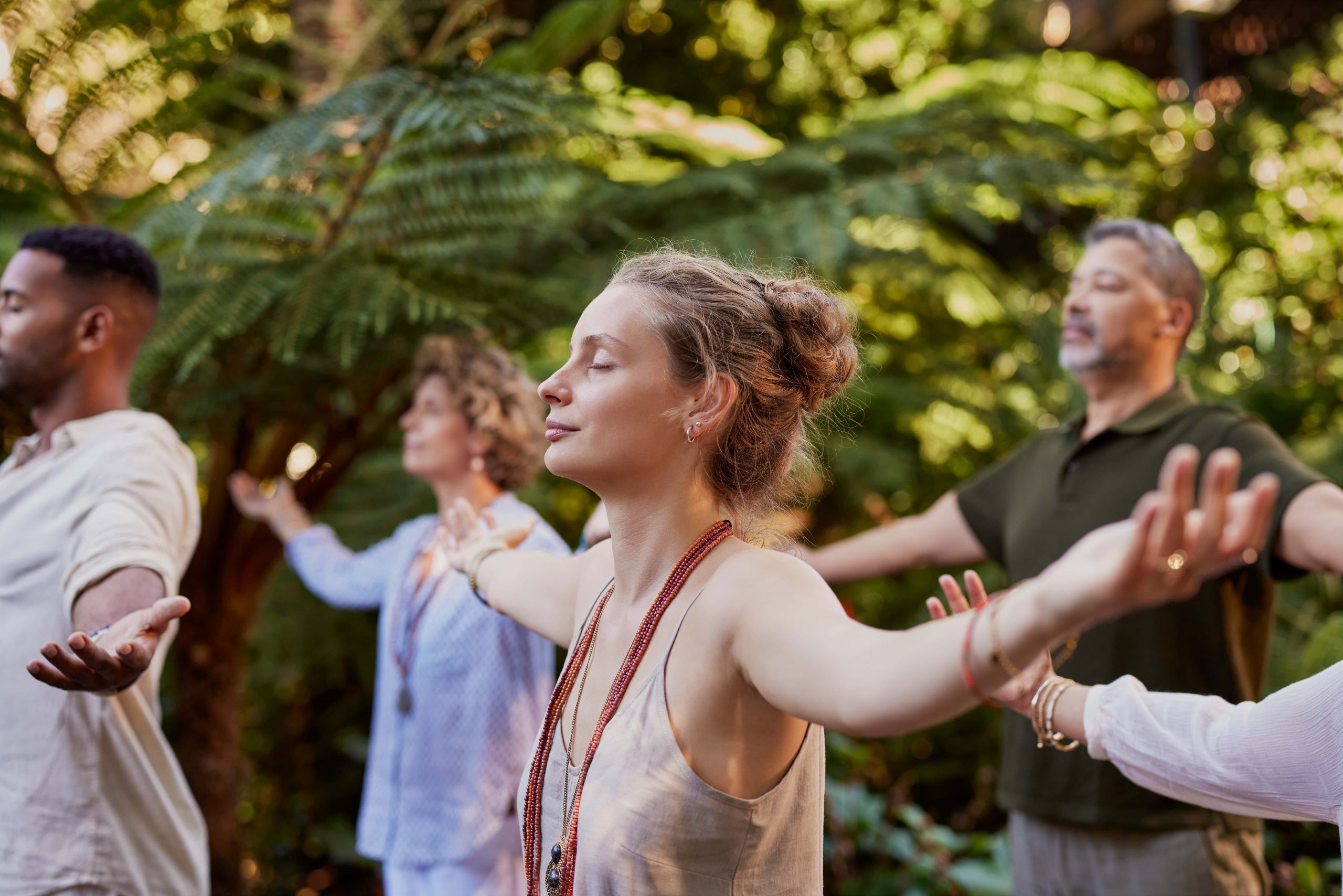 young-woman-meditating-with-a-group-of-diverse-people